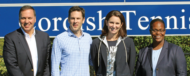 President Liebowitz, Jonathan and Melissa Cordish, and Lauren Haynie stand in front of a Cordish Tennis Center sign.